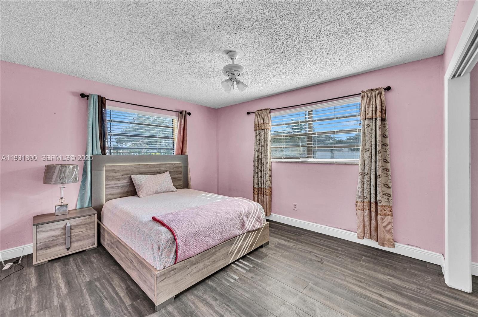 4751 Northwest 5th Court Plantation, FL 33317 - Photo 20 of 34 a bedroom with a large bed and a chandelier