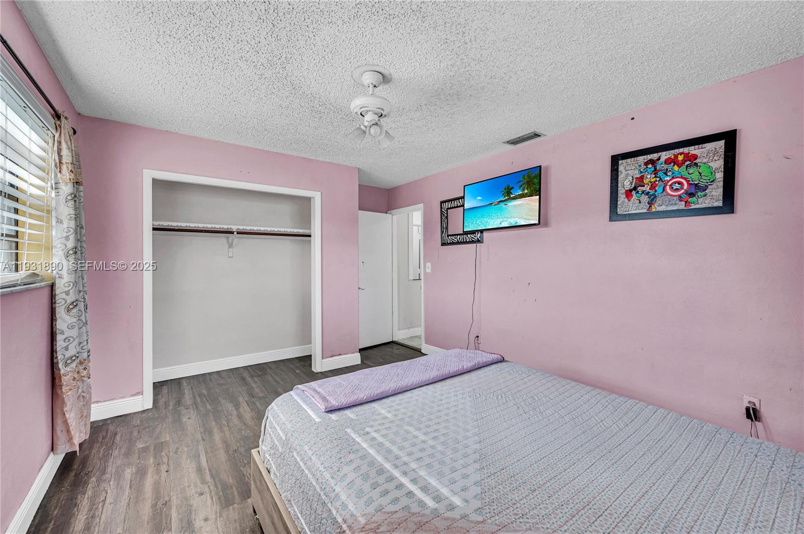 4751 Northwest 5th Court Plantation, FL 33317 - Photo 21 of 34 a bedroom with a bed and a chandelier