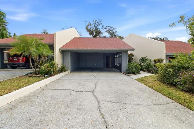 a view of a white house with a yard and plants