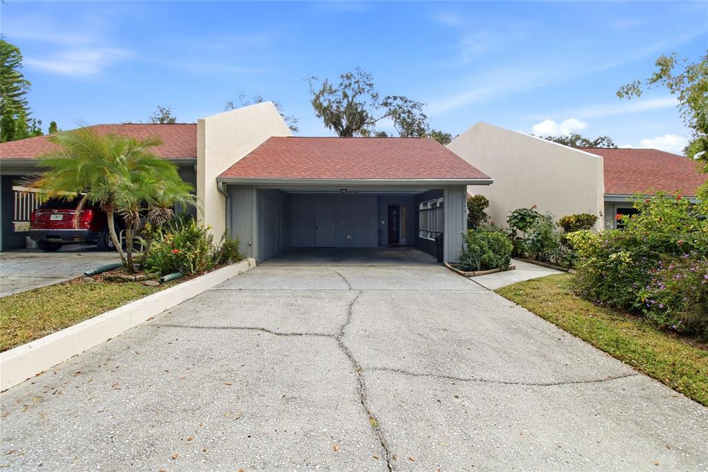 a view of a white house with a yard and plants