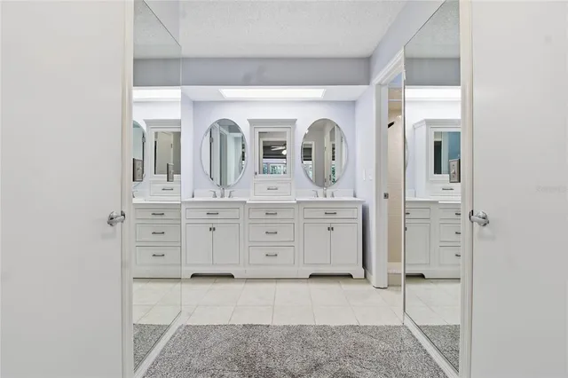a bathroom with a double vanity sink mirror and toilet