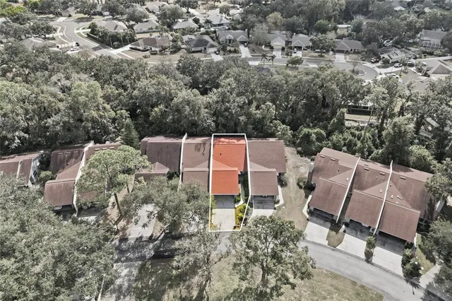 an aerial view of a house with garden space and street view
