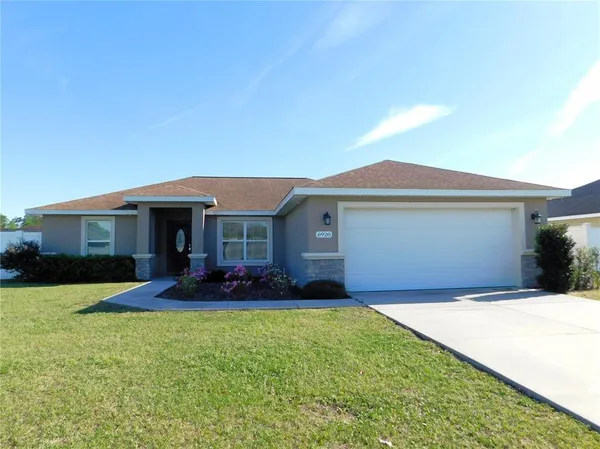 a front view of a house with a yard and porch