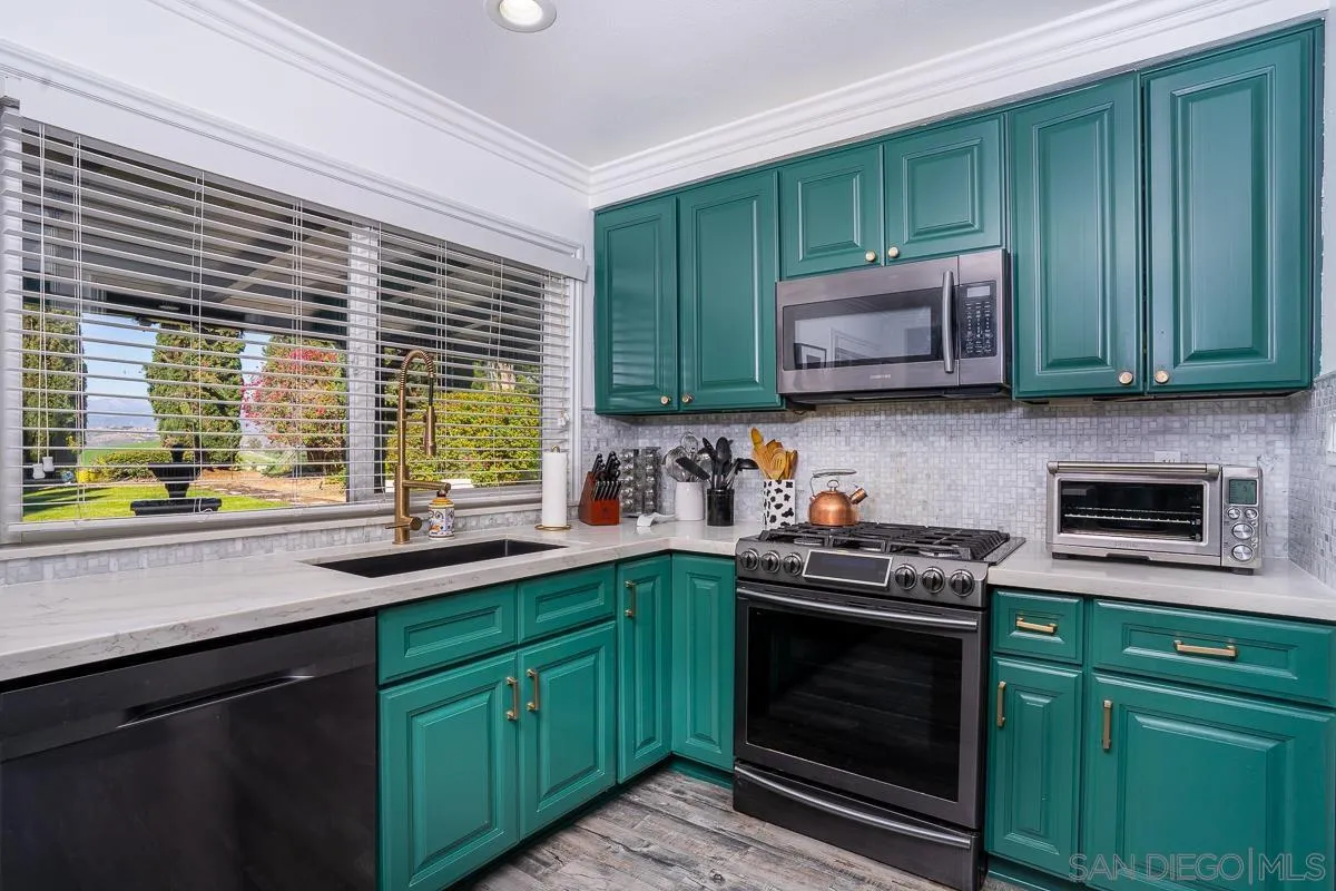 23615 Decorah Road Diamond Bar, CA 91765 - Photo 14 of 42 a kitchen with granite countertop cabinets stainless steel appliances and a sink