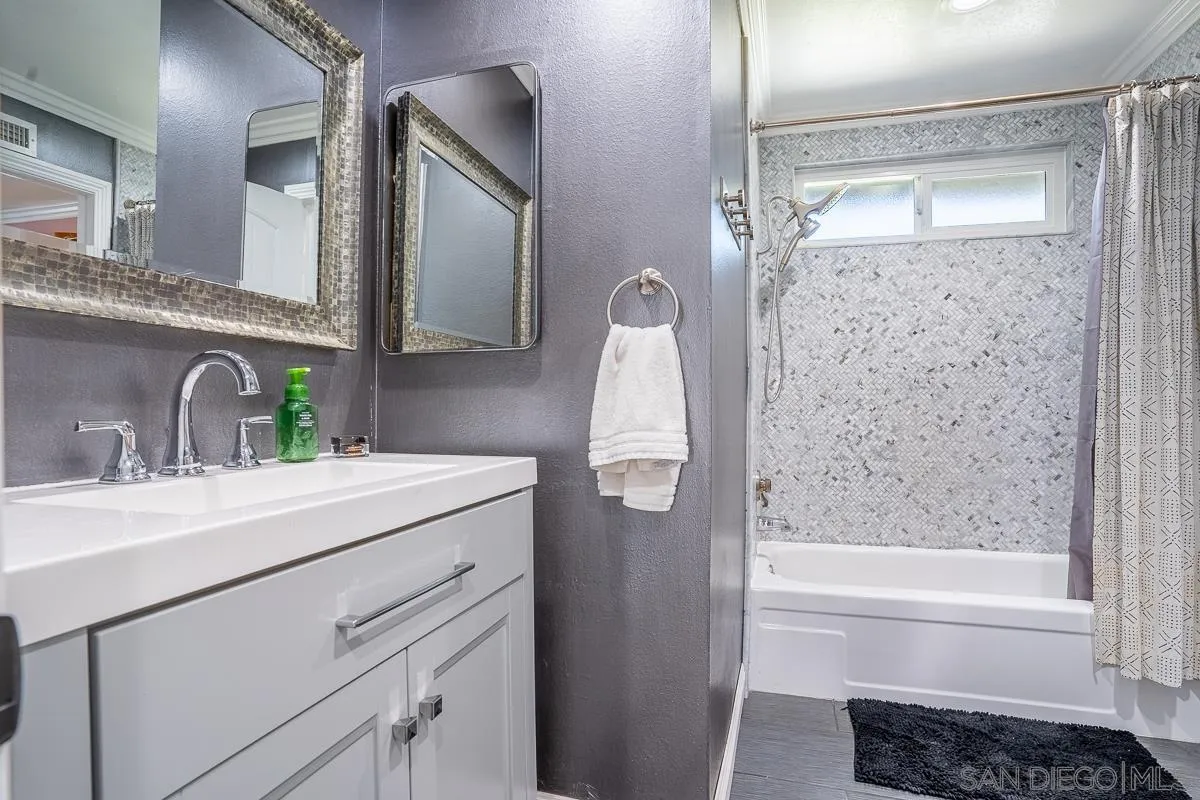 23615 Decorah Road Diamond Bar, CA 91765 - Photo 23 of 42 a bathroom with a sink a mirror a vanity and shower