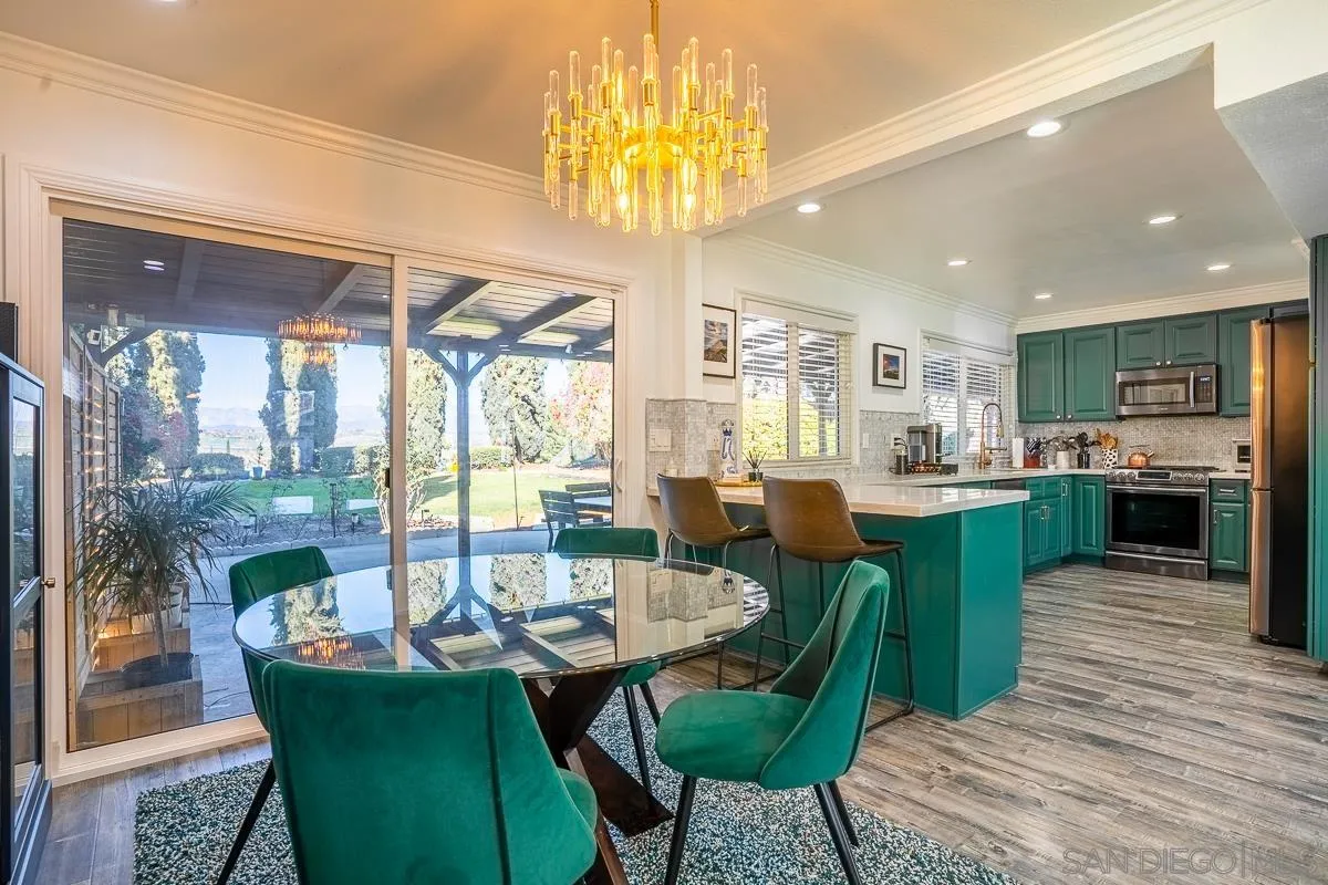 23615 Decorah Road Diamond Bar, CA 91765 - Photo 10 of 42 a view of a dining room with furniture a chandelier and wooden floor