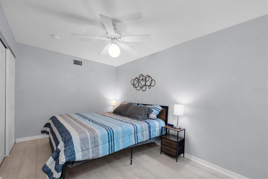 819 10th Street Southwest Largo, FL 33770 - Photo 13 of 85 a bedroom with a bed and a chandelier
