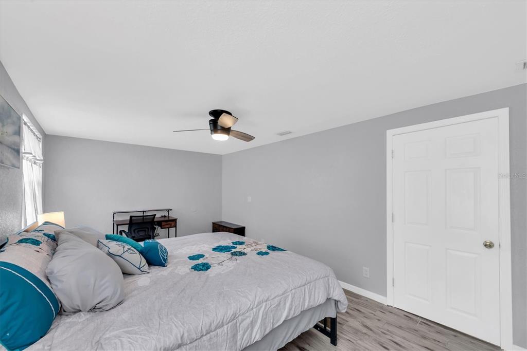 819 10th Street Southwest Largo, FL 33770 - Photo 17 of 85 a bedroom with a bed and wooden floor