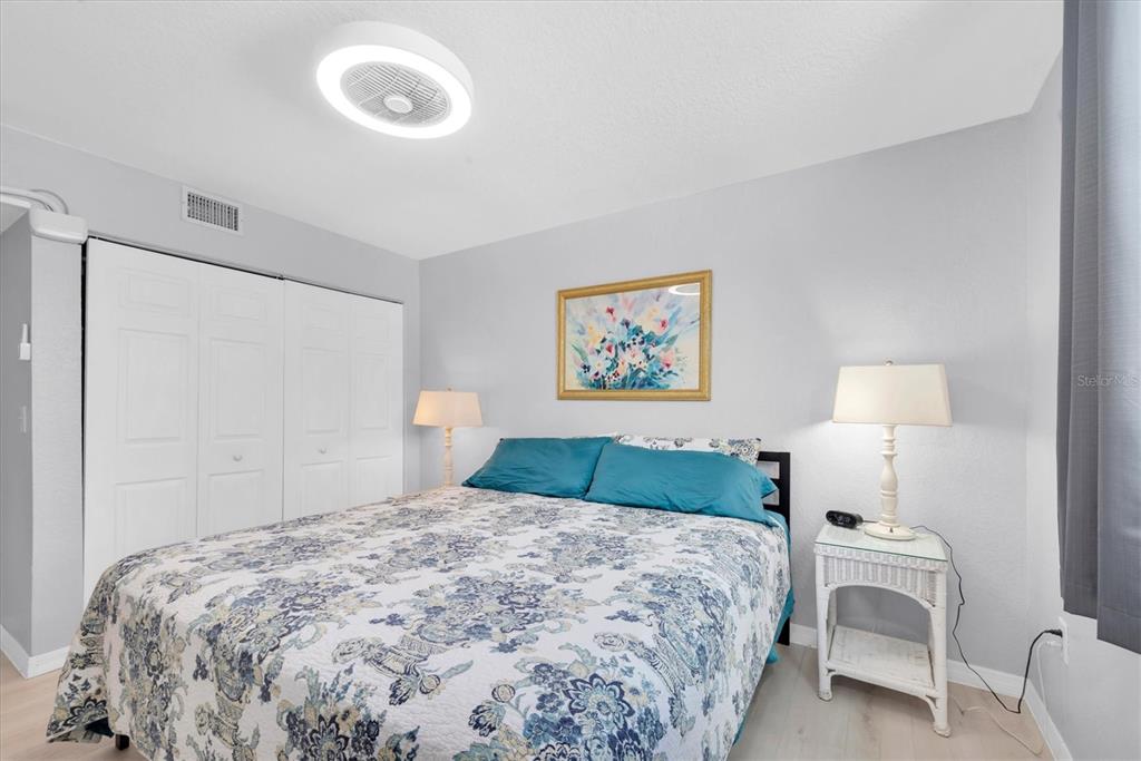 819 10th Street Southwest Largo, FL 33770 - Photo 23 of 85 a bedroom with a bed and a lamp on dresser