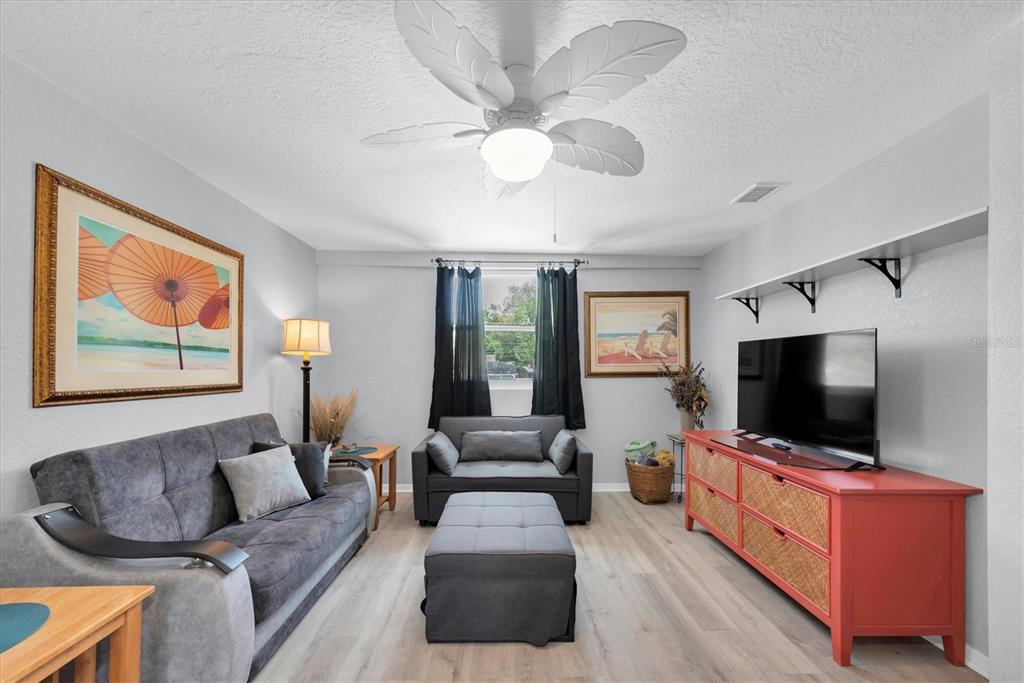 819 10th Street Southwest Largo, FL 33770 - Photo 28 of 85 a living room with furniture and a flat screen tv