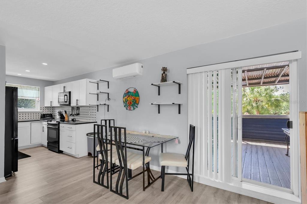 819 10th Street Southwest Largo, FL 33770 - Photo 31 of 85 a kitchen with a table chairs refrigerator and microwave