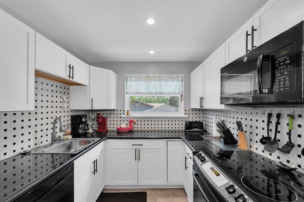 819 10th Street Southwest Largo, FL 33770 - Photo 34 of 85 a kitchen with stainless steel appliances a sink a stove and a refrigerator