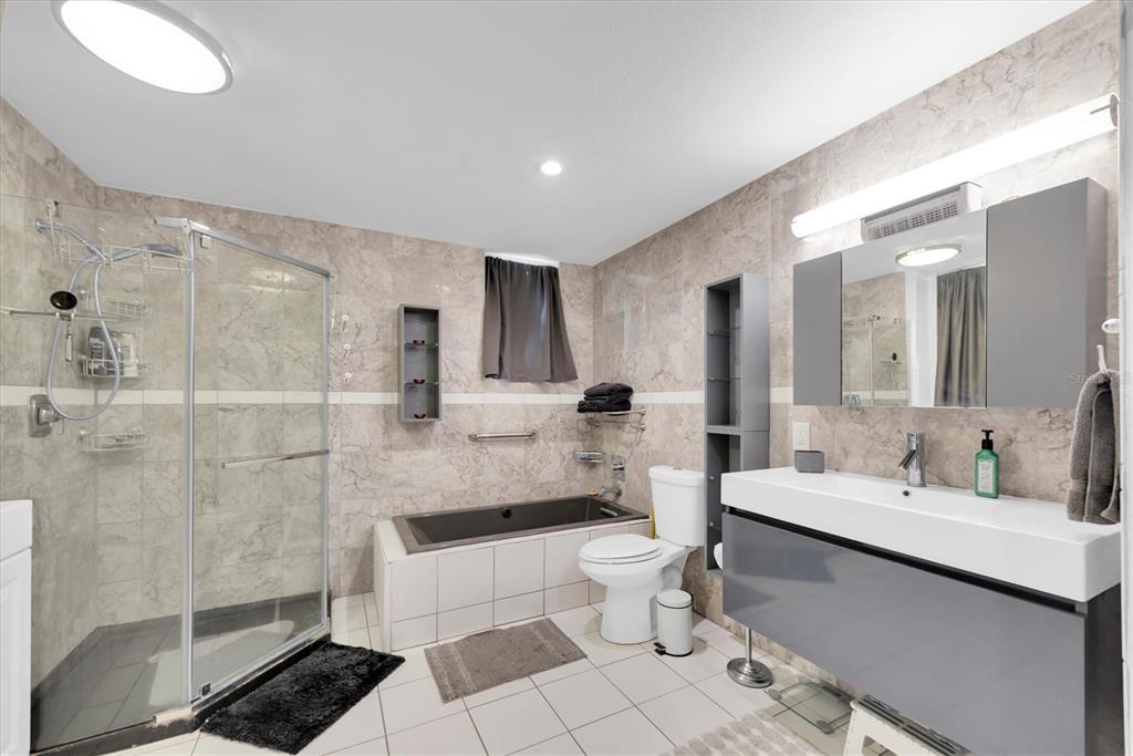 819 10th Street Southwest Largo, FL 33770 - Photo 36 of 85 a bathroom with a double vanity sink toilet and shower