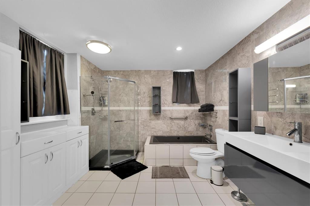 819 10th Street Southwest Largo, FL 33770 - Photo 37 of 85 a bathroom with a double vanity sink toilet and shower