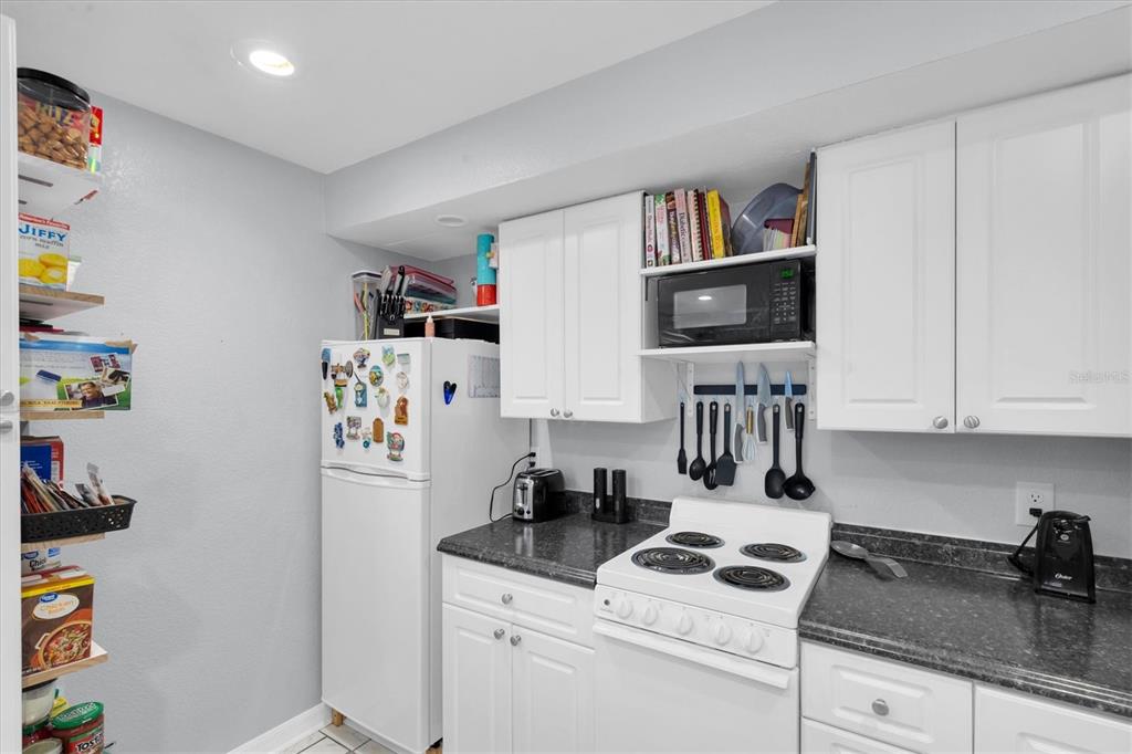 819 10th Street Southwest Largo, FL 33770 - Photo 51 of 85 a kitchen with stainless steel appliances granite countertop a refrigerator a stove a sink and dishwasher