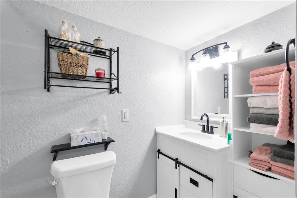 819 10th Street Southwest Largo, FL 33770 - Photo 53 of 85 a bathroom with a toilet a sink and mirror