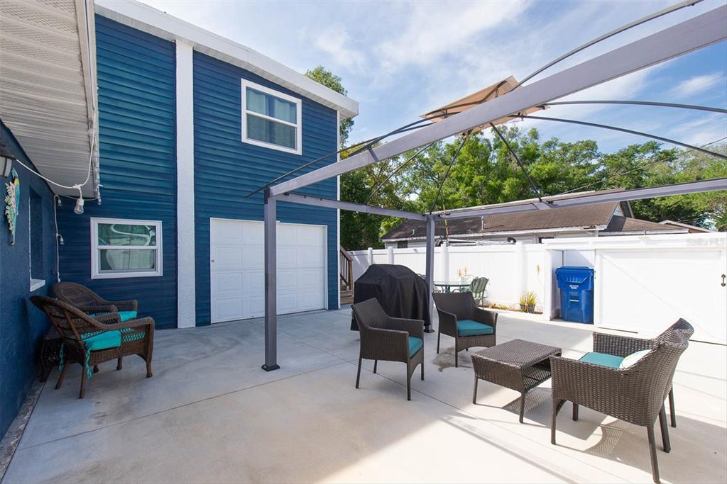 819 10th Street Southwest Largo, FL 33770 - Photo 75 of 85 a view of a chairs and table in the patio next to a yard