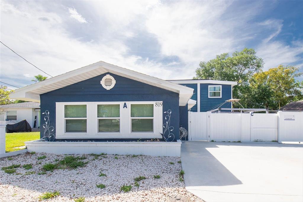 819 10th Street Southwest Largo, FL 33770 - Photo 80 of 85 a front view of a house with a yard and garage