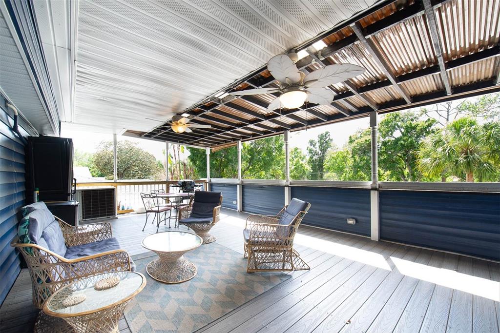 819 10th Street Southwest Largo, FL 33770 - Photo 85 of 85 a view of a patio with table and chairs and wooden floor