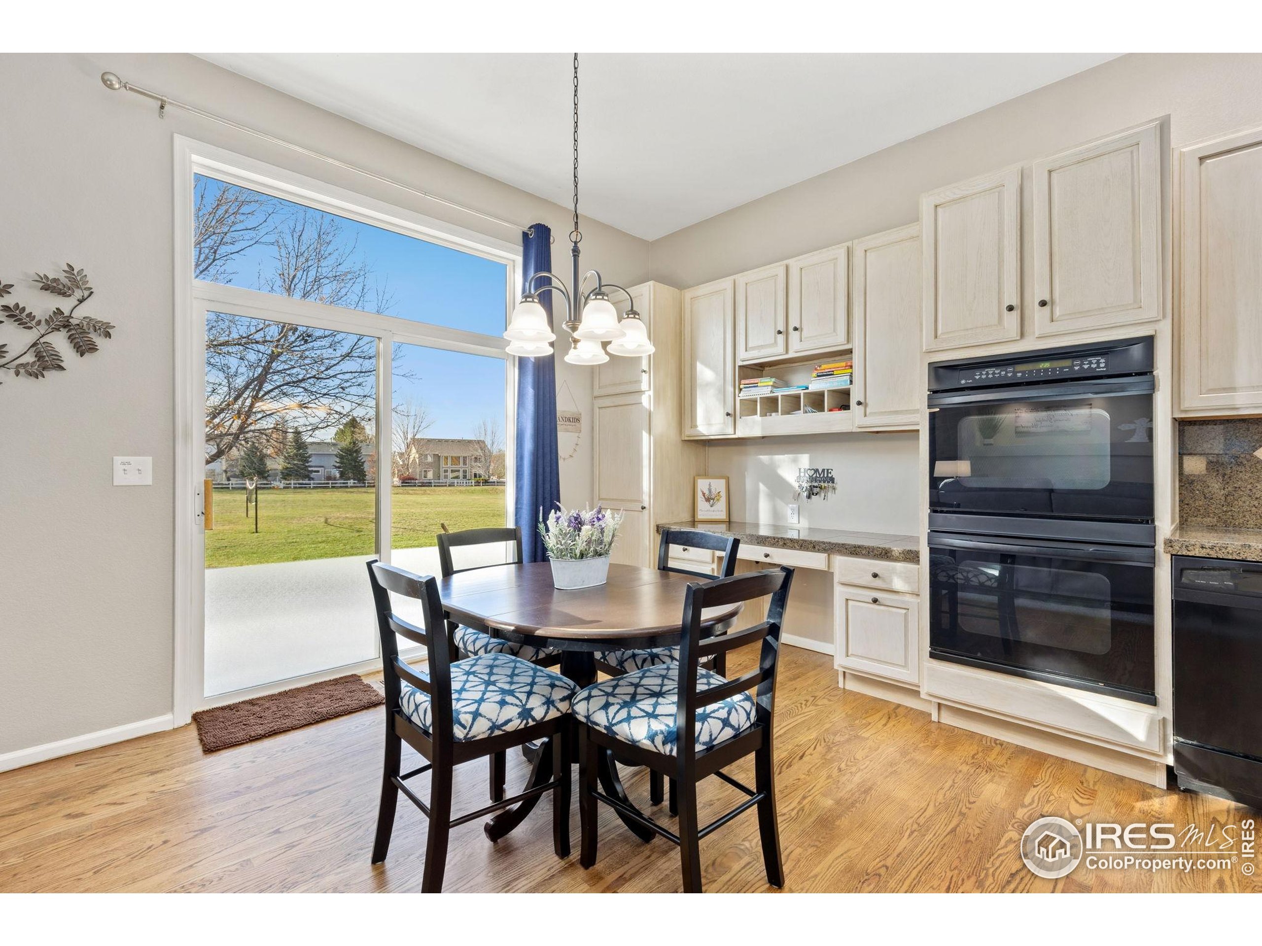 10166 Scenic Court Firestone, CO 80504 - Photo 11 of 33 a view of a dining room with furniture window and wooden floor