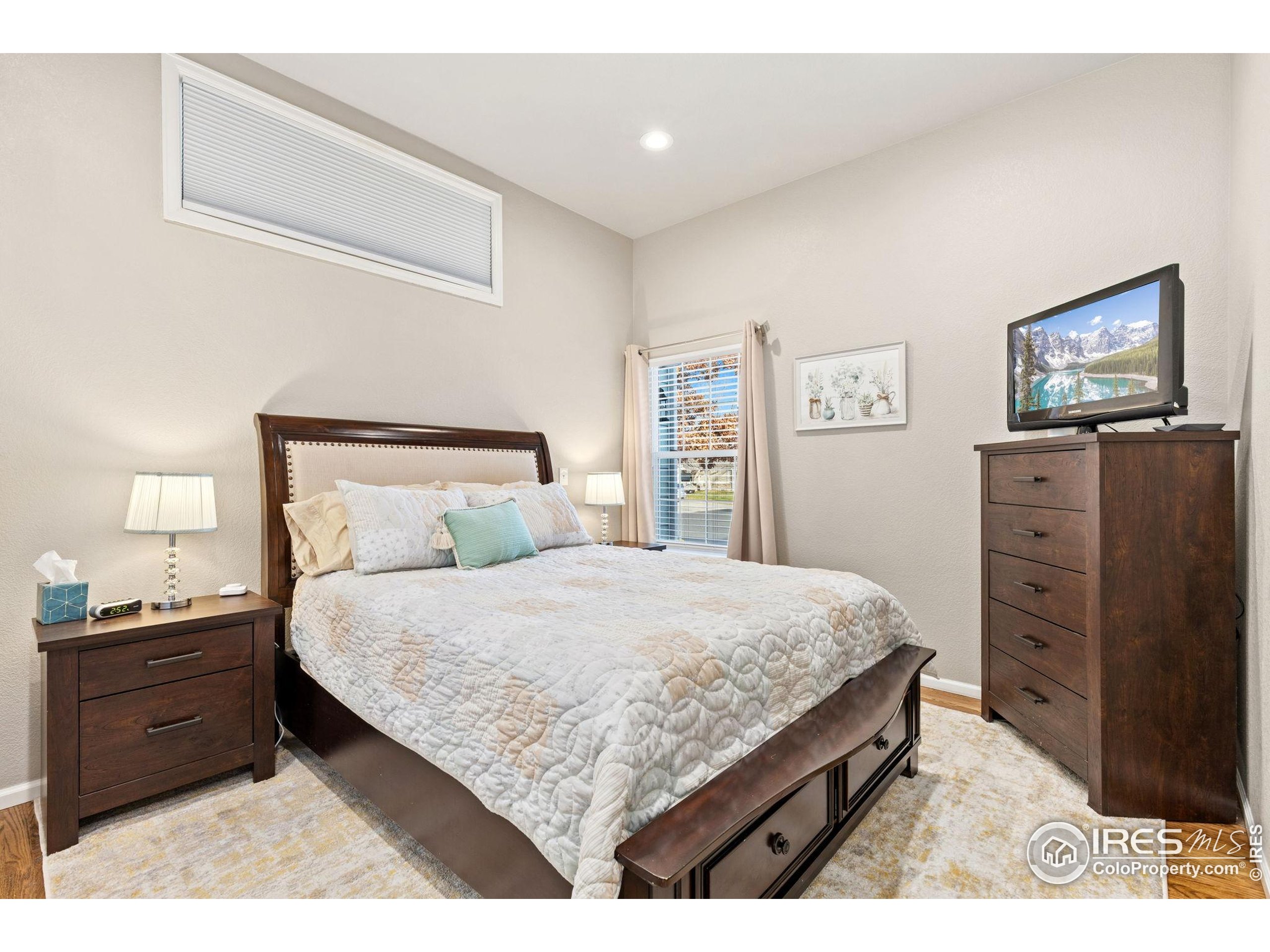 10166 Scenic Court Firestone, CO 80504 - Photo 19 of 33 a bedroom with a bed and furniture