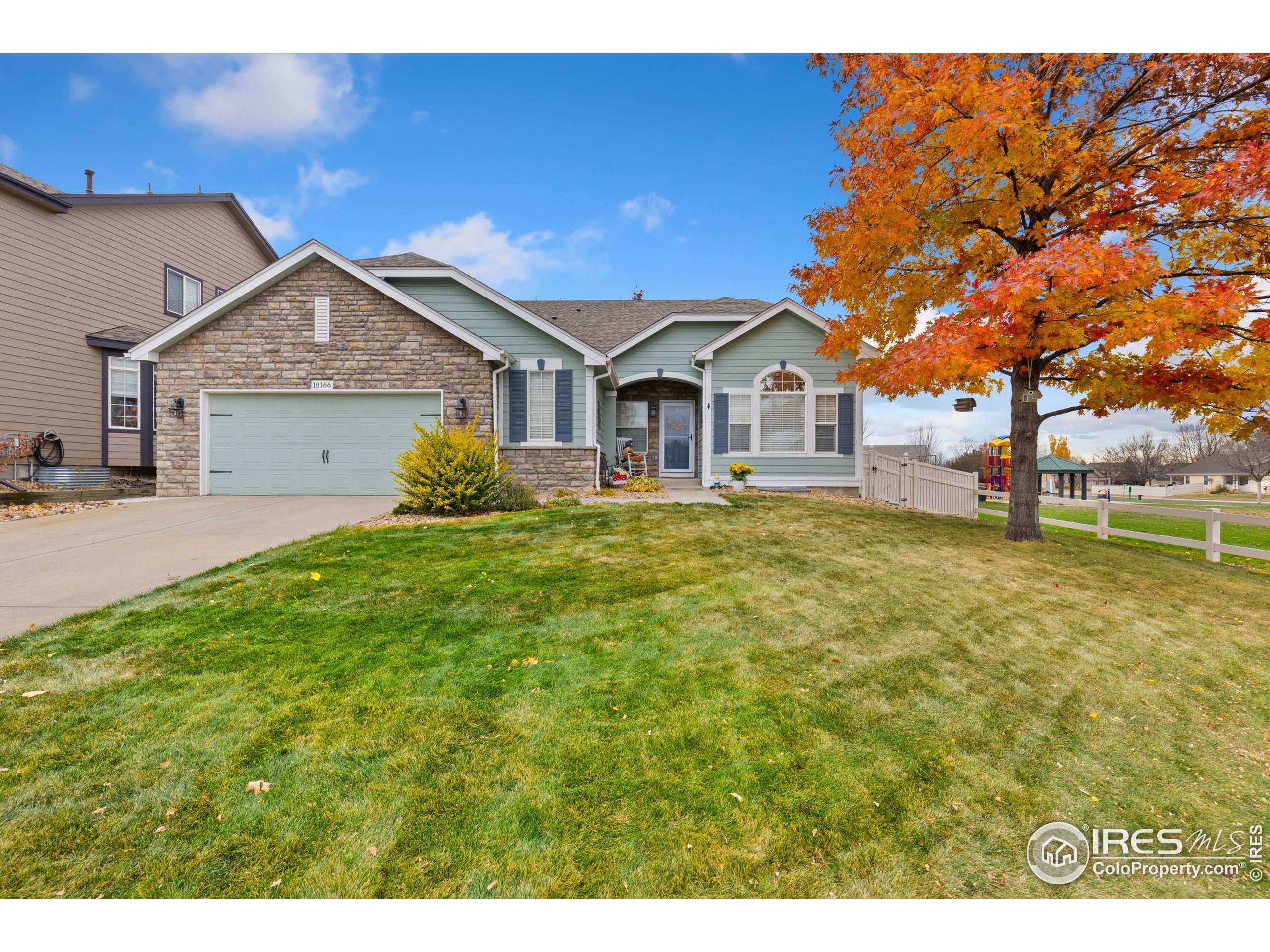 10166 Scenic Court Firestone, CO 80504 - Photo 2 of 33 a front view of a house with a yard and garage