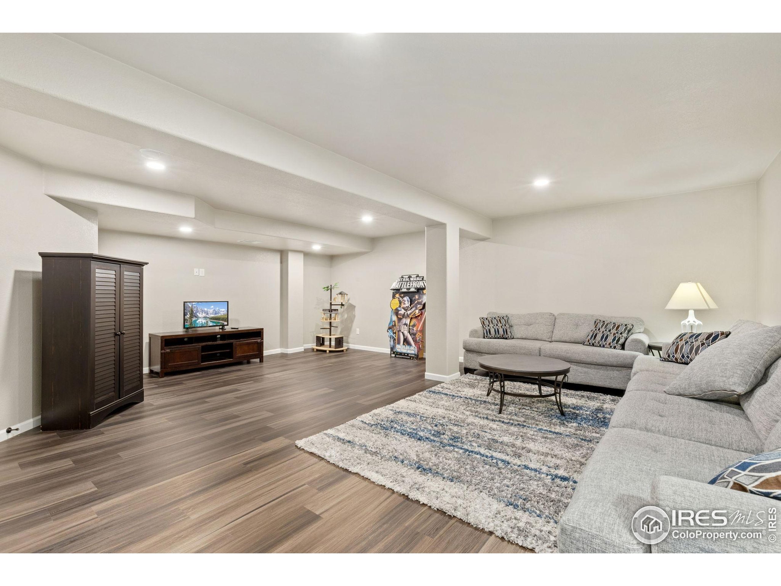 10166 Scenic Court Firestone, CO 80504 - Photo 24 of 33 a living room with furniture and a wooden floor