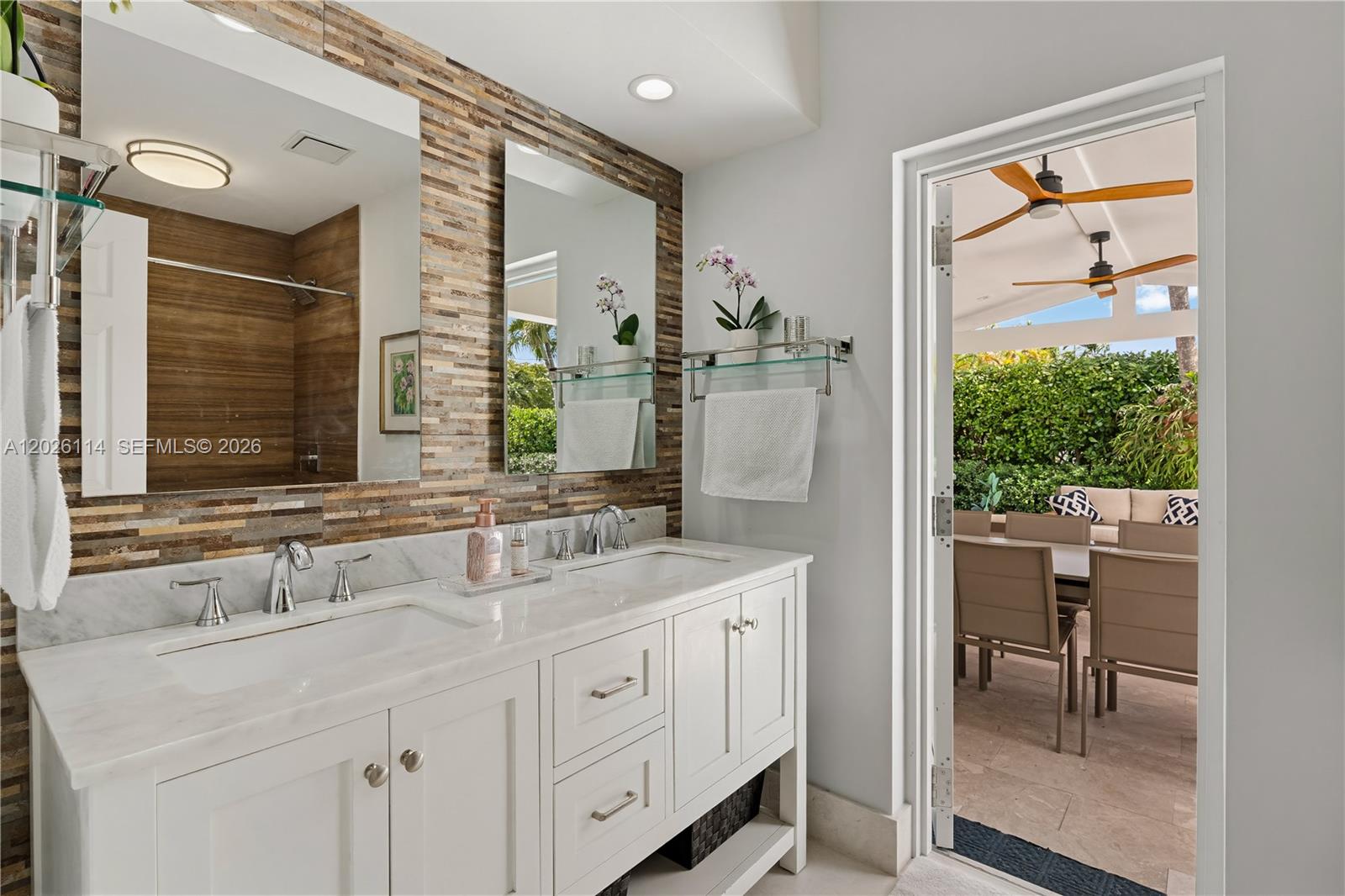9641 Southwest 66th Street Miami, FL 33173 - Photo 30 of 57 a bathroom with a double vanity sink and a mirror