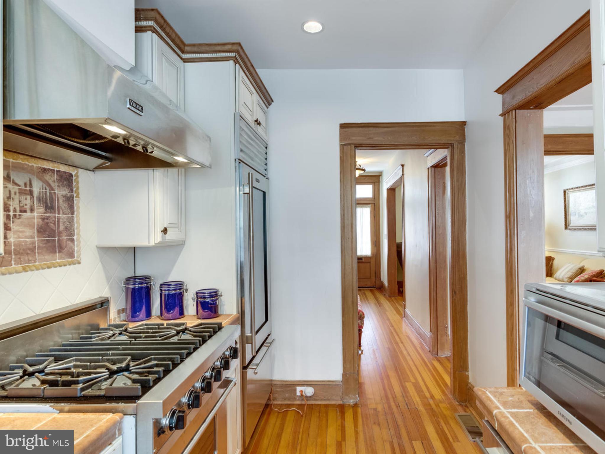 1654 33rd Street Northwest Washington, DC 20007 - Photo 11 of 17 a kitchen with stainless steel appliances granite countertop a stove and a wooden floor