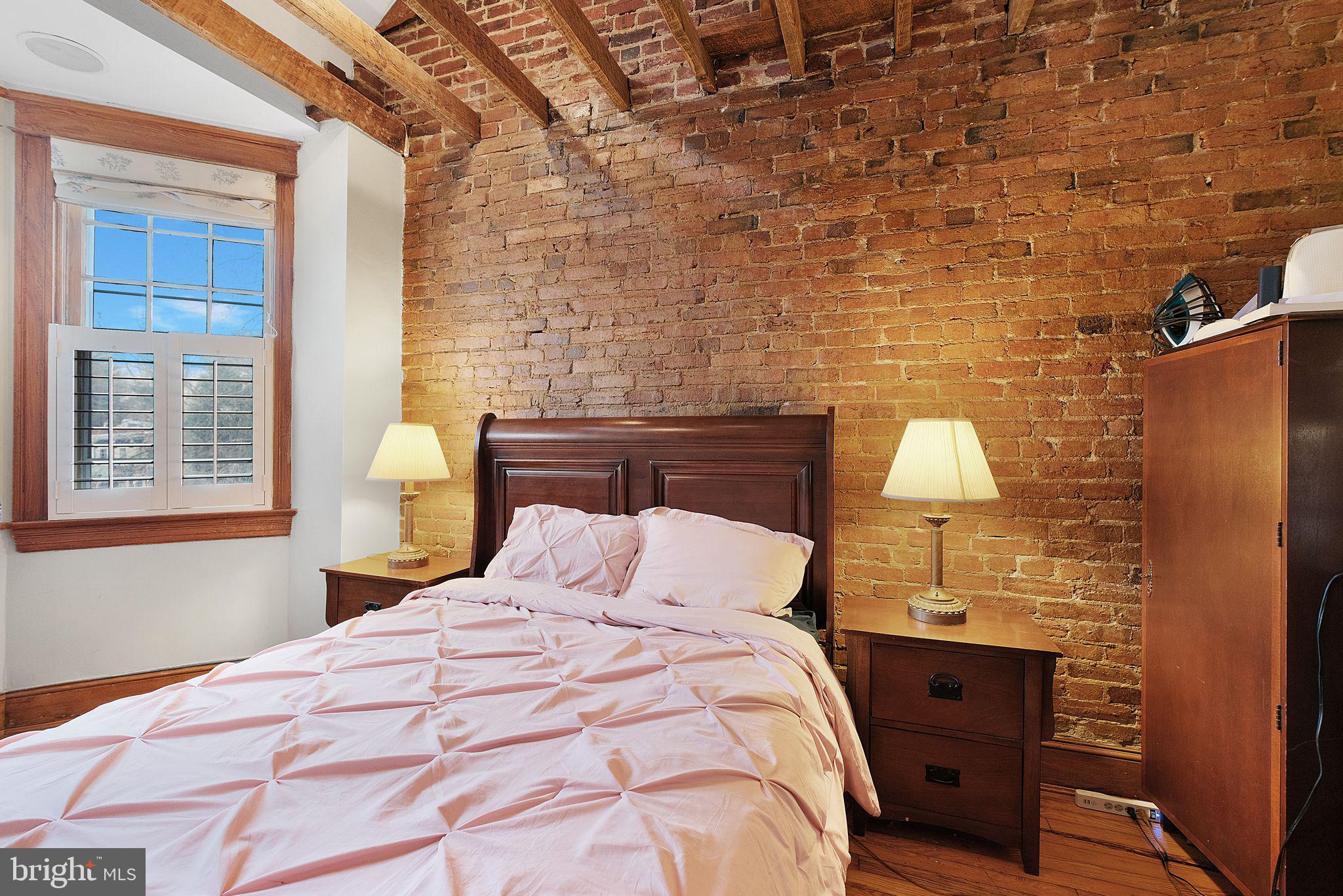 1654 33rd Street Northwest Washington, DC 20007 - Photo 15 of 17 a bedroom with a bed and a lamp on dresser