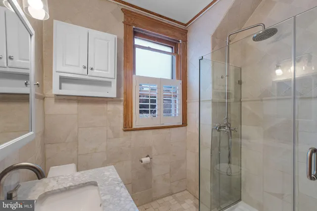 a bathroom with a tub shower and sink
