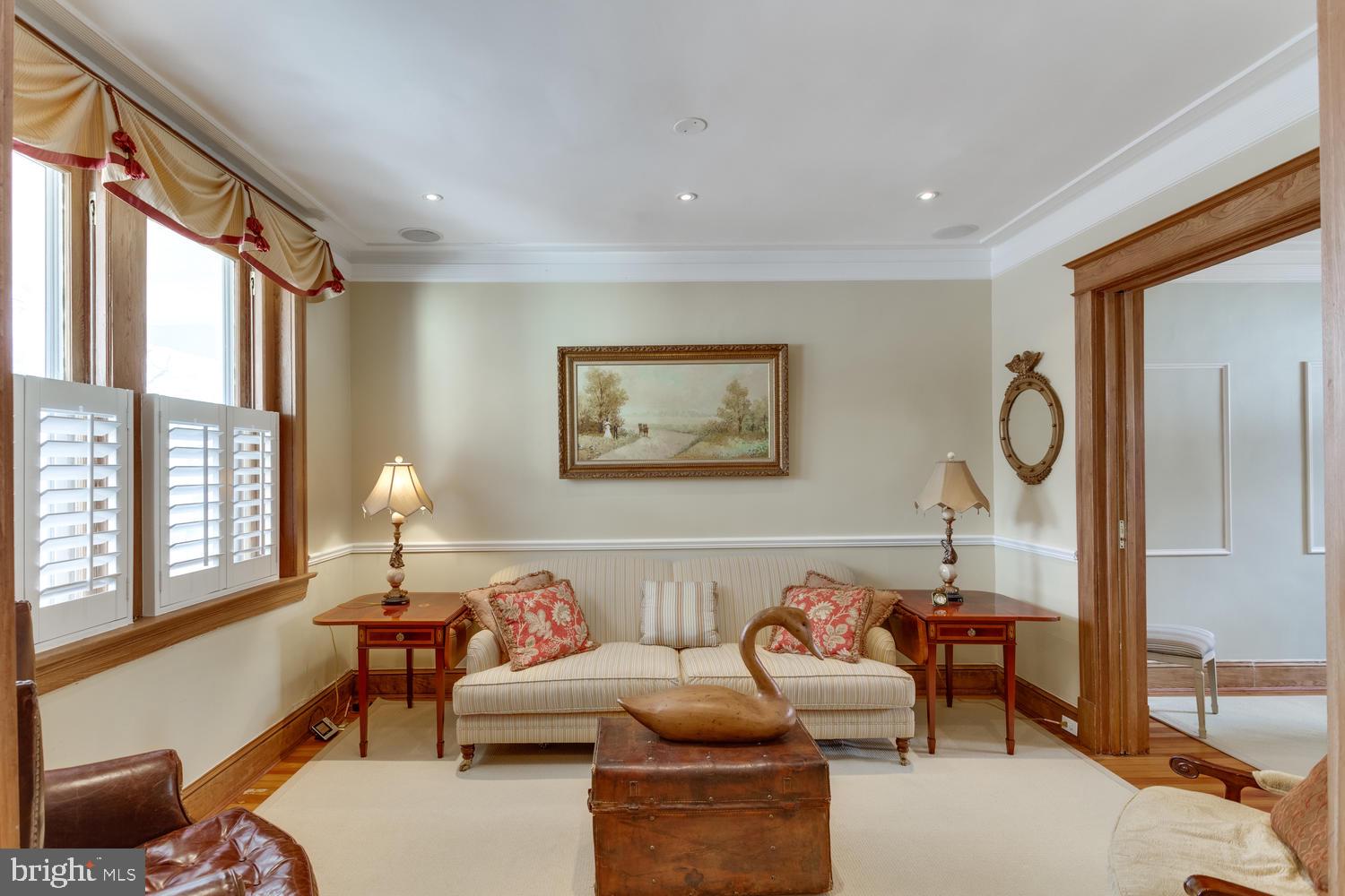 1654 33rd Street Northwest Washington, DC 20007 - Photo 4 of 17 a living room with furniture a large window and a chandelier