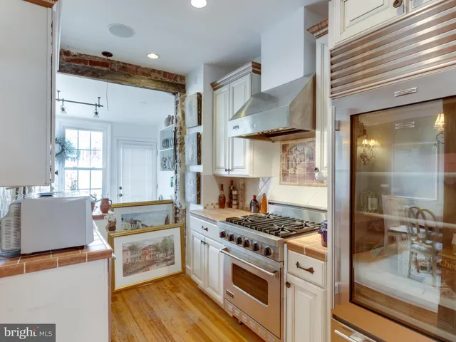 a kitchen with stainless steel appliances granite countertop a stove and a sink