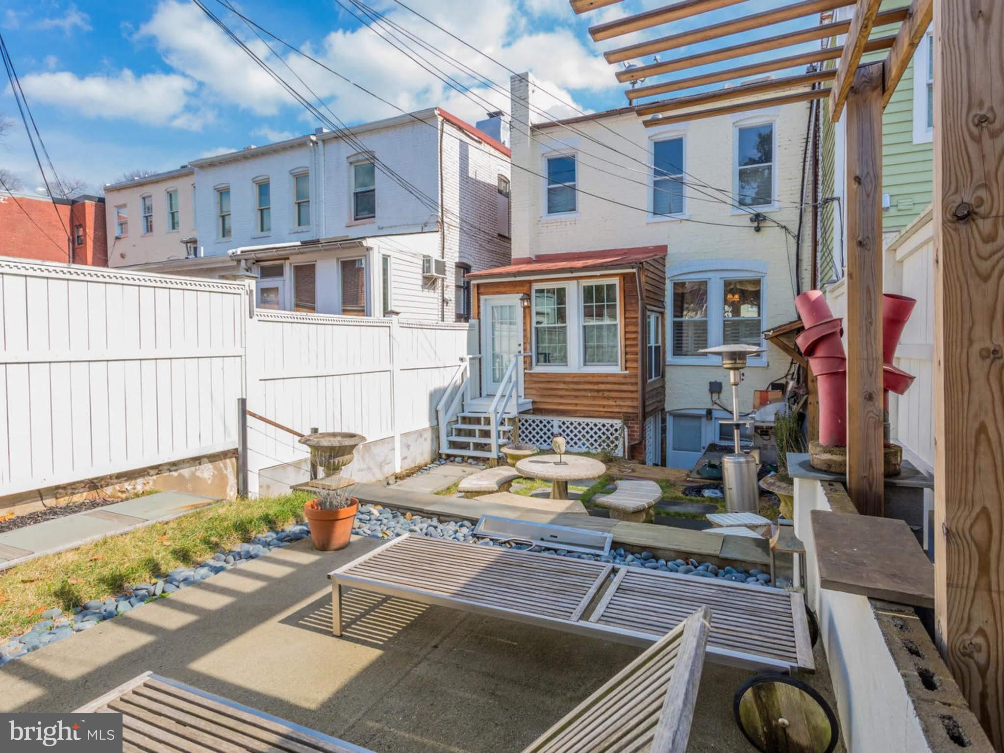 1654 33rd Street Northwest Washington, DC 20007 - Photo 9 of 17 a view of a patio with couches table and chairs and wooden floor