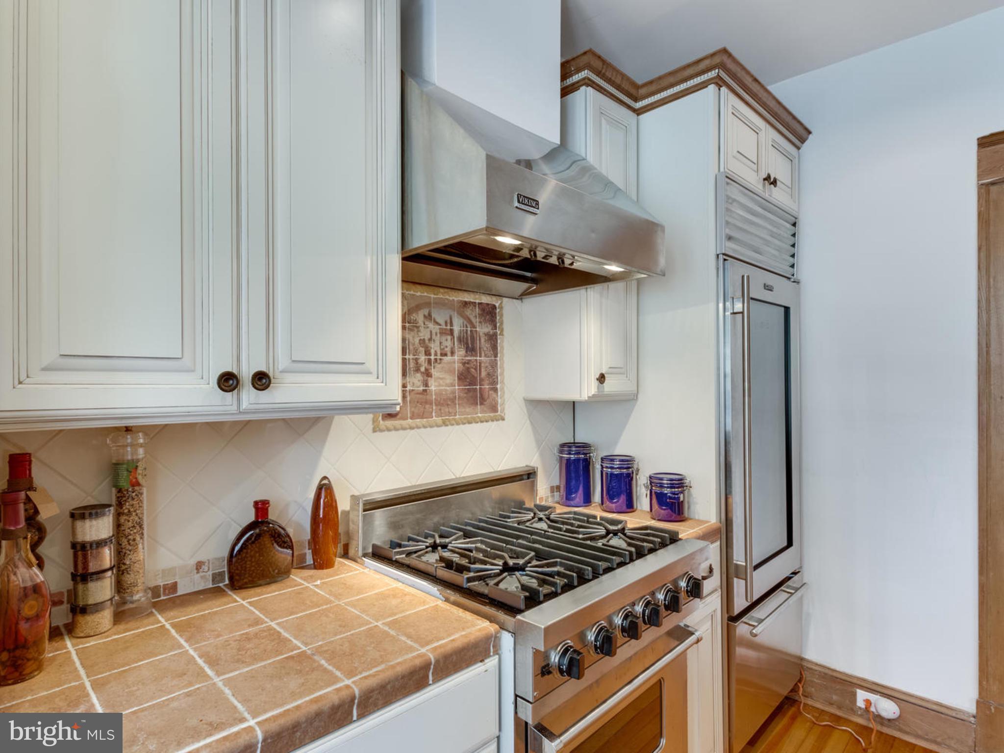 1654 33rd Street Northwest Washington, DC 20007 - Photo 10 of 17 a kitchen with a stove and cabinets