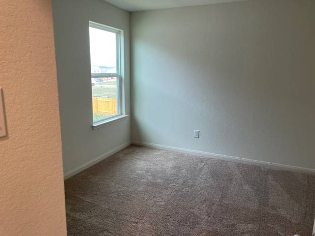 18812 Speculator Lane Elgin, TX 78621 - Photo 20 of 24 Unfurnished room with a textured wall and carpet floors