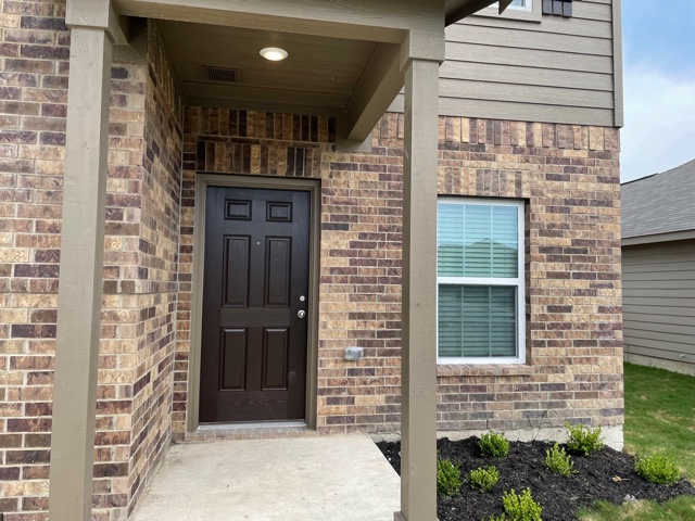 18812 Speculator Lane Elgin, TX 78621 - Photo 4 of 24 Property entrance featuring brick siding