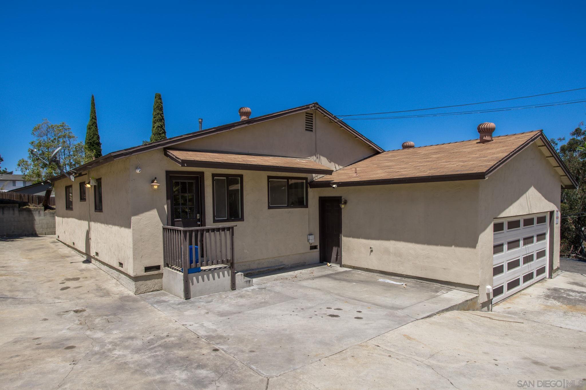 6643 San Miguel Lemon Grove, CA 91945 - Photo 15 of 34 a view of a house with a yard and garage