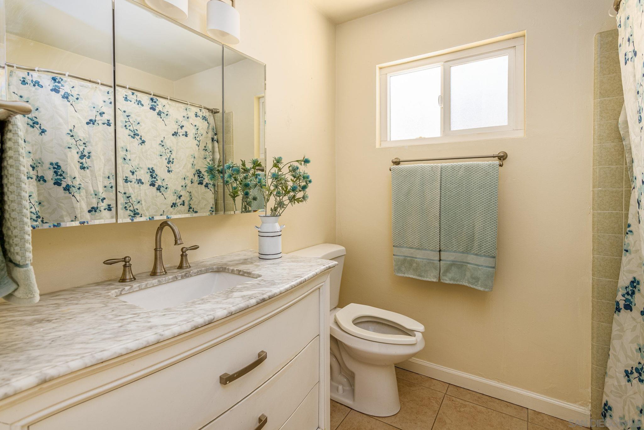 6643 San Miguel Lemon Grove, CA 91945 - Photo 28 of 34 a bathroom with a granite countertop sink toilet and shower
