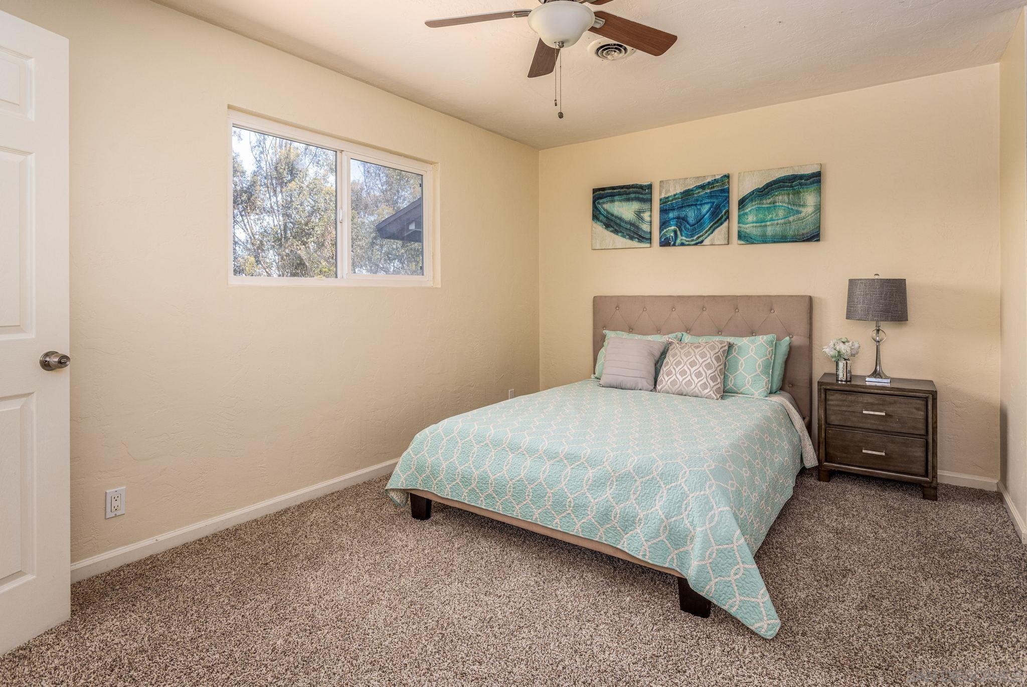 6643 San Miguel Lemon Grove, CA 91945 - Photo 31 of 34 a bedroom with a bed and a painting on the wall