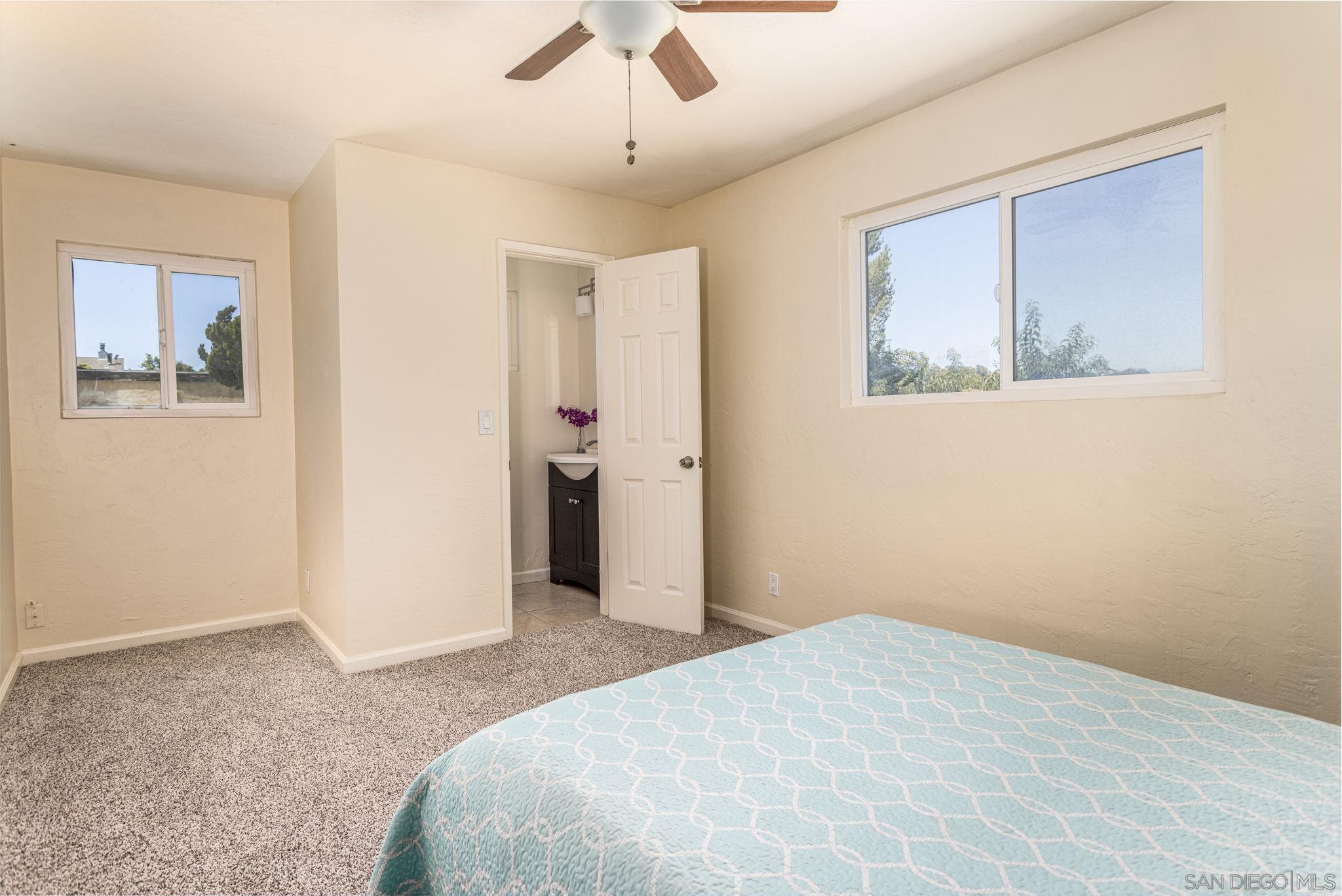6643 San Miguel Lemon Grove, CA 91945 - Photo 32 of 34 a bedroom with a bed and a painting on the wall