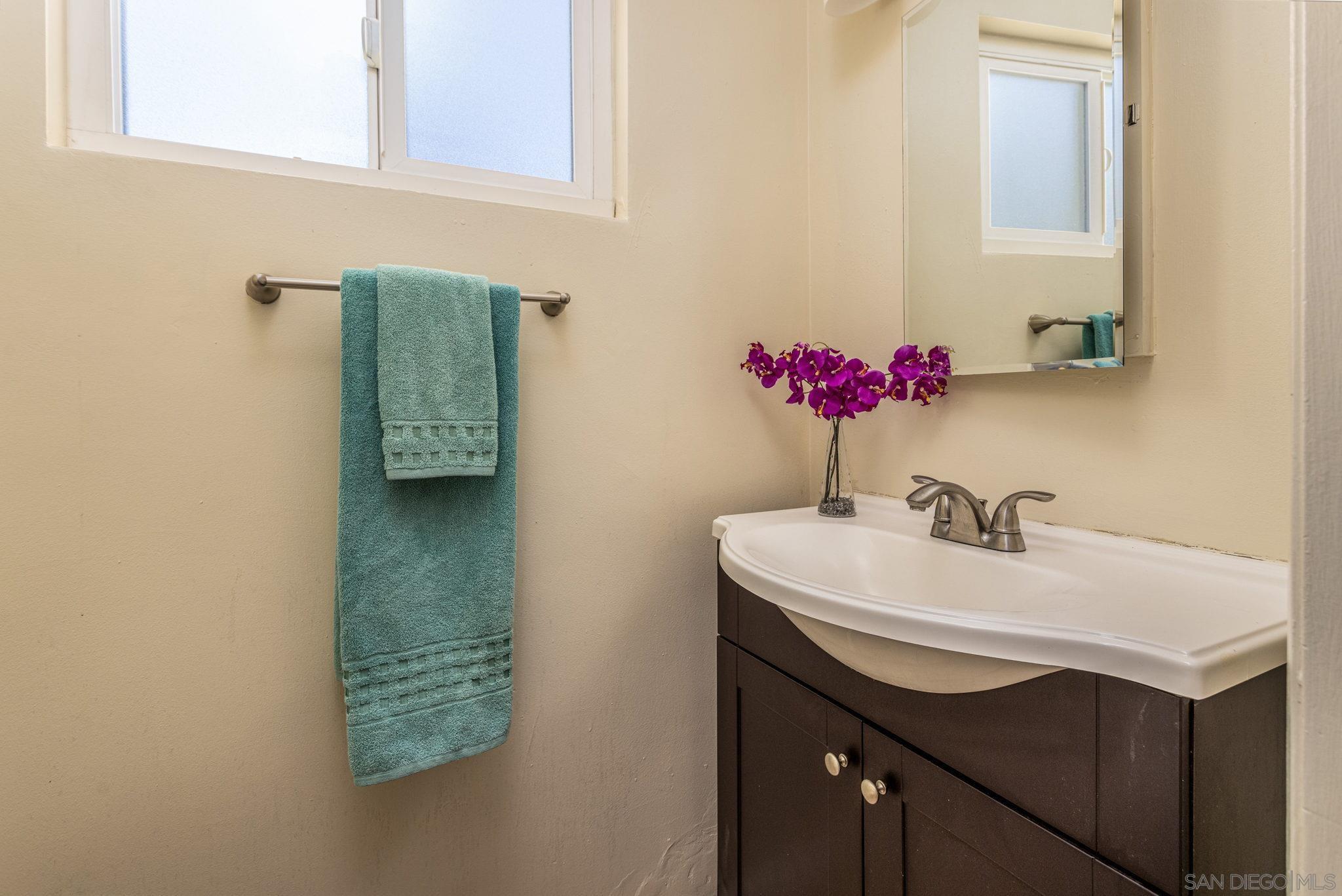 6643 San Miguel Lemon Grove, CA 91945 - Photo 33 of 34 a bathroom with a sink and a mirror
