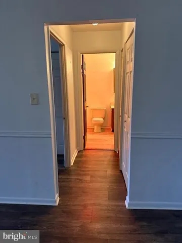 a view of a room with wooden floor