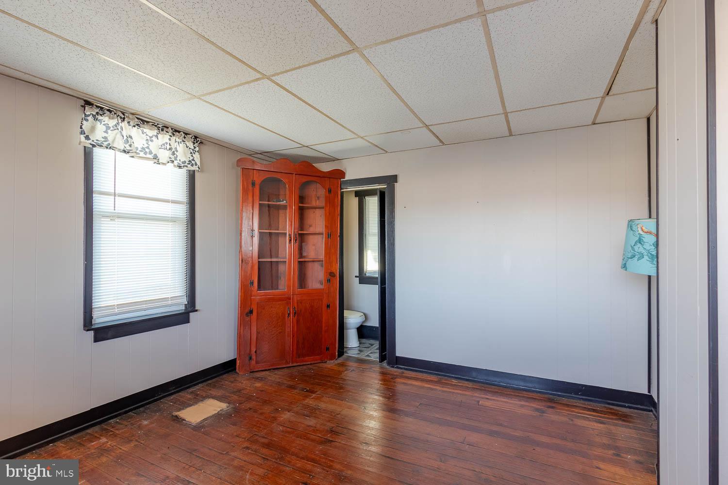 200 Stumptown Road Osceola Mills, PA 16666 - Photo 11 of 30 an empty room with wooden floor and windows
