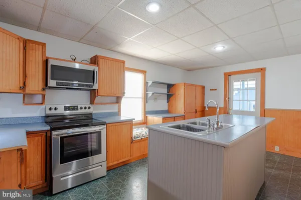 a kitchen that has a sink and a stove top oven