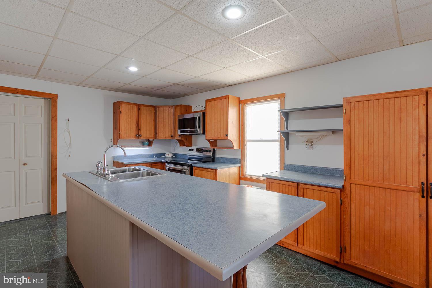 200 Stumptown Road Osceola Mills, PA 16666 - Photo 4 of 30 a kitchen with stainless steel appliances granite countertop a refrigerator a sink dishwasher a stove a dining table and chairs with wooden floor
