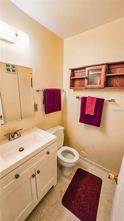 5660 80th Street North, Unit A303 St. Petersburg, FL 33709 - Photo 18 of 72 a bathroom with a sink mirror vanity and toilet