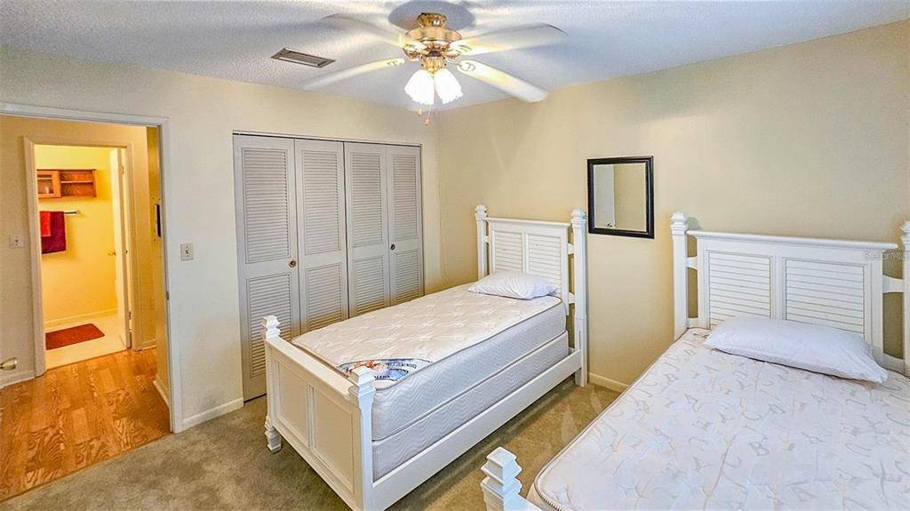 5660 80th Street North, Unit A303 St. Petersburg, FL 33709 - Photo 21 of 72 a bedroom with a bed and a chandelier