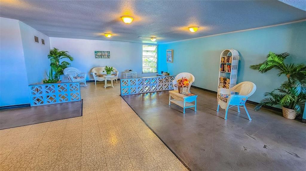 5660 80th Street North, Unit A303 St. Petersburg, FL 33709 - Photo 25 of 72 a living room with furniture and a potted plant