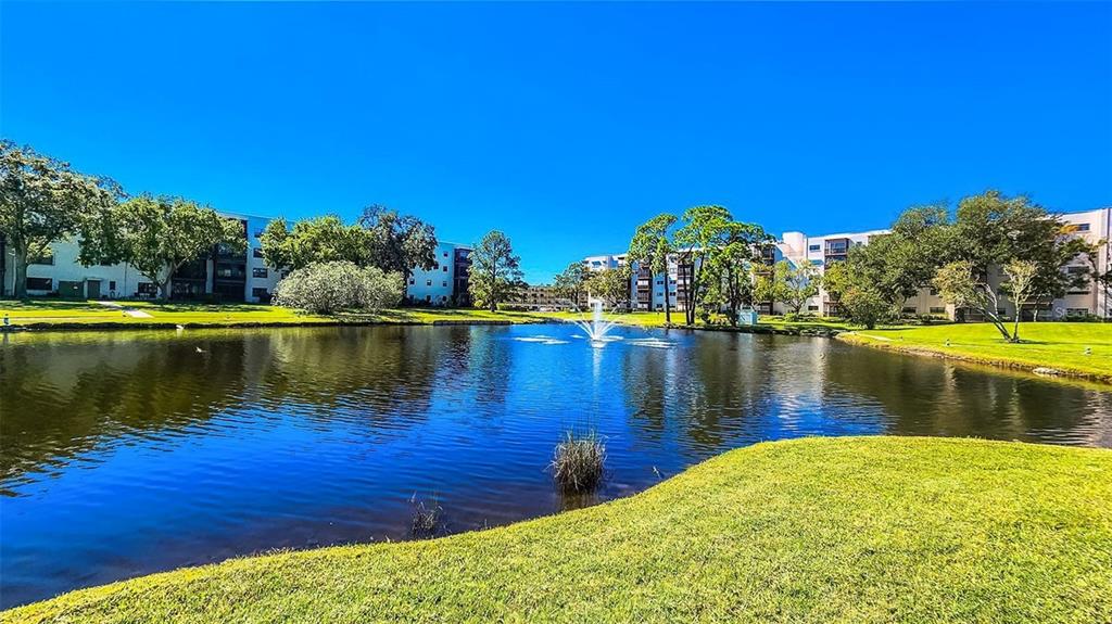 5660 80th Street North, Unit A303 St. Petersburg, FL 33709 - Photo 35 of 72 a view of a lake with a building in the background